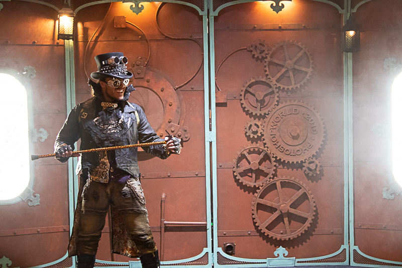 Steampunk cosplayer three-quarter view — intense expression, elaborate outfit